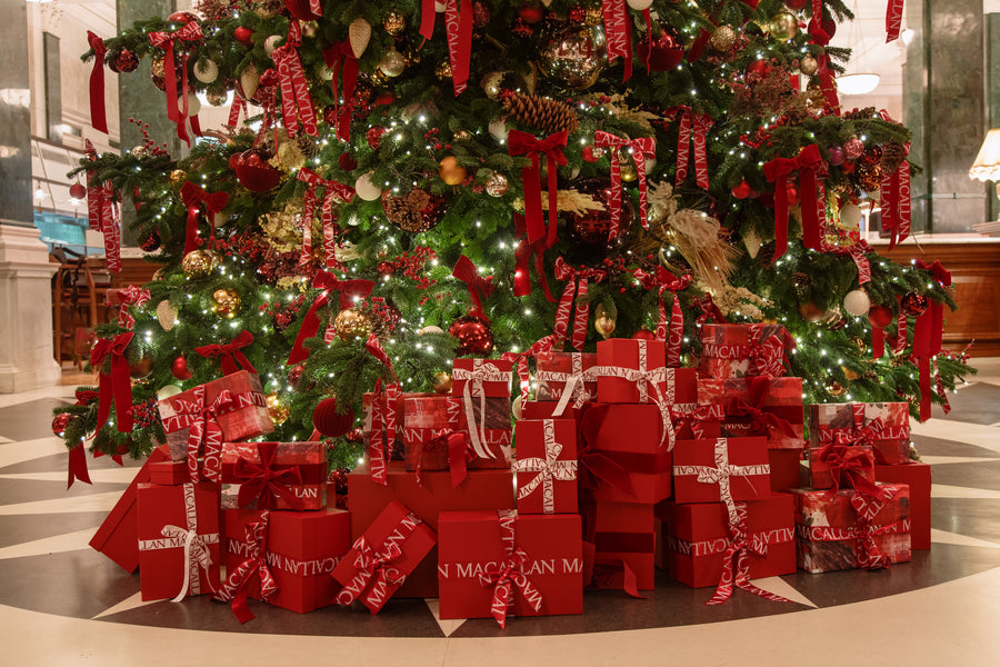 The tree set against the marble alcove with surrounding floral arrangements